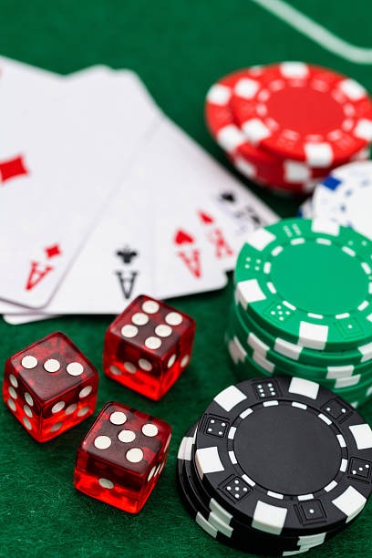 Mobile phone displaying Domino QQ live dealer table with player hands, betting controls, and chat panel
